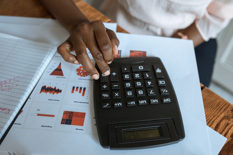 An accountant analyzing corporate income statement expenses on a laptop screen